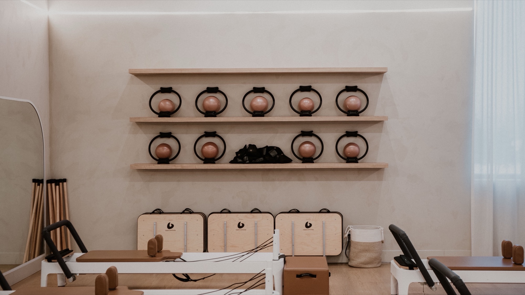 Étagère de matériel Pilates (anneaux et ballons) et plateau de reformers du studio Blackburn Pilates Saint-Bruno